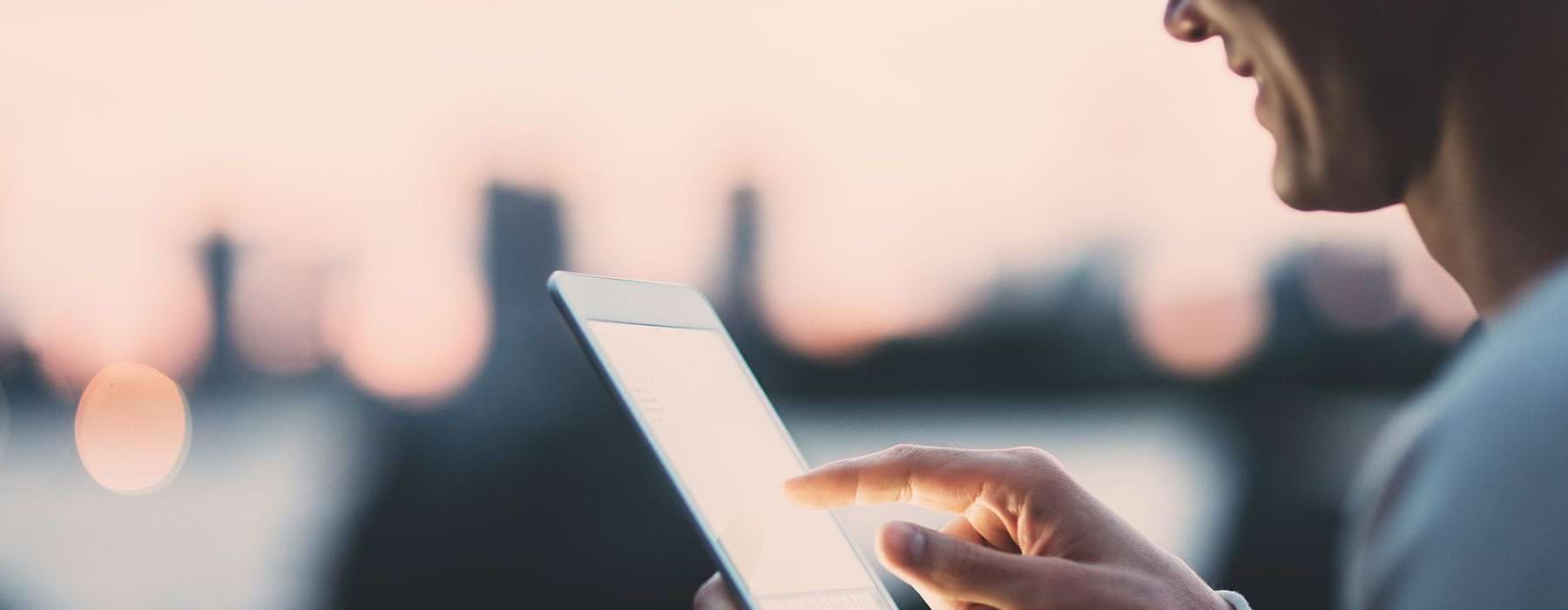 lifestyle image of a man looking onto a smart device